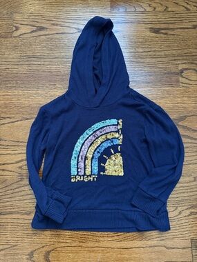 Rumi + Ryder navy pullover sweater with yellow tag detail